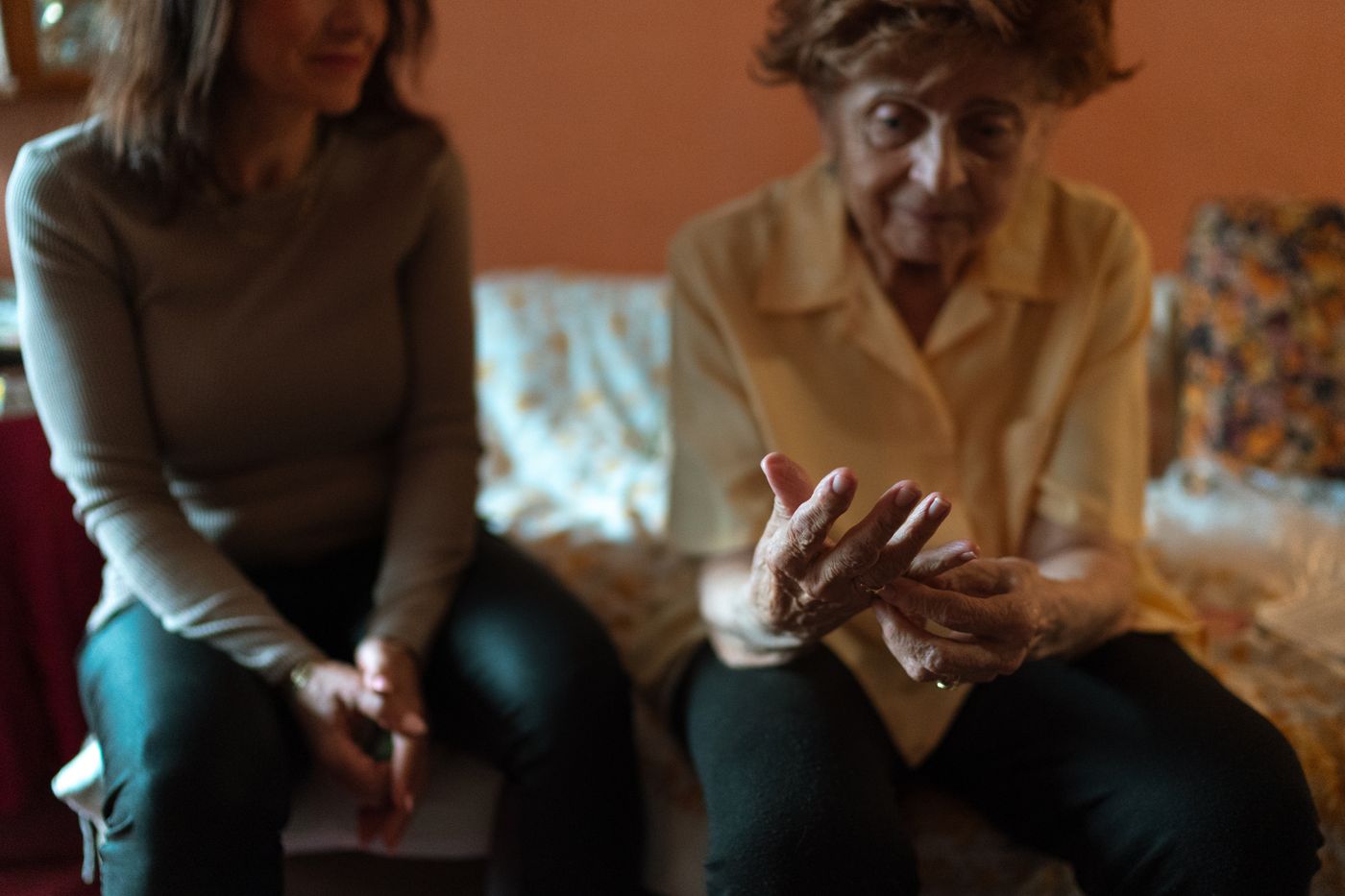 A caregiver connecting with an older woman in her living room