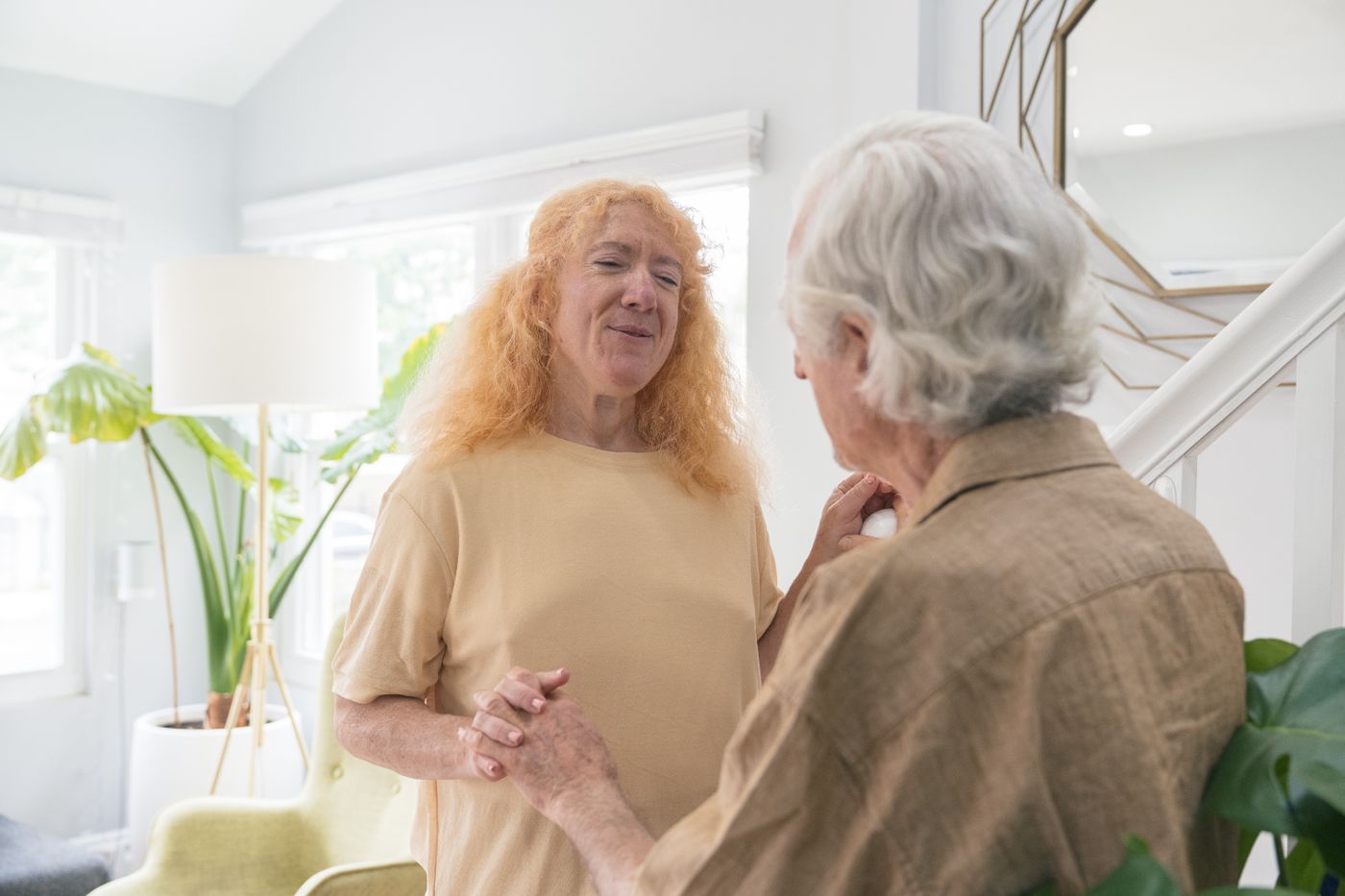 An older couple holding hands and smiling