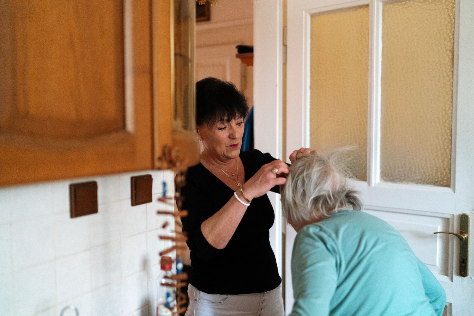 A caregiver assisting an older adult with a daily routine